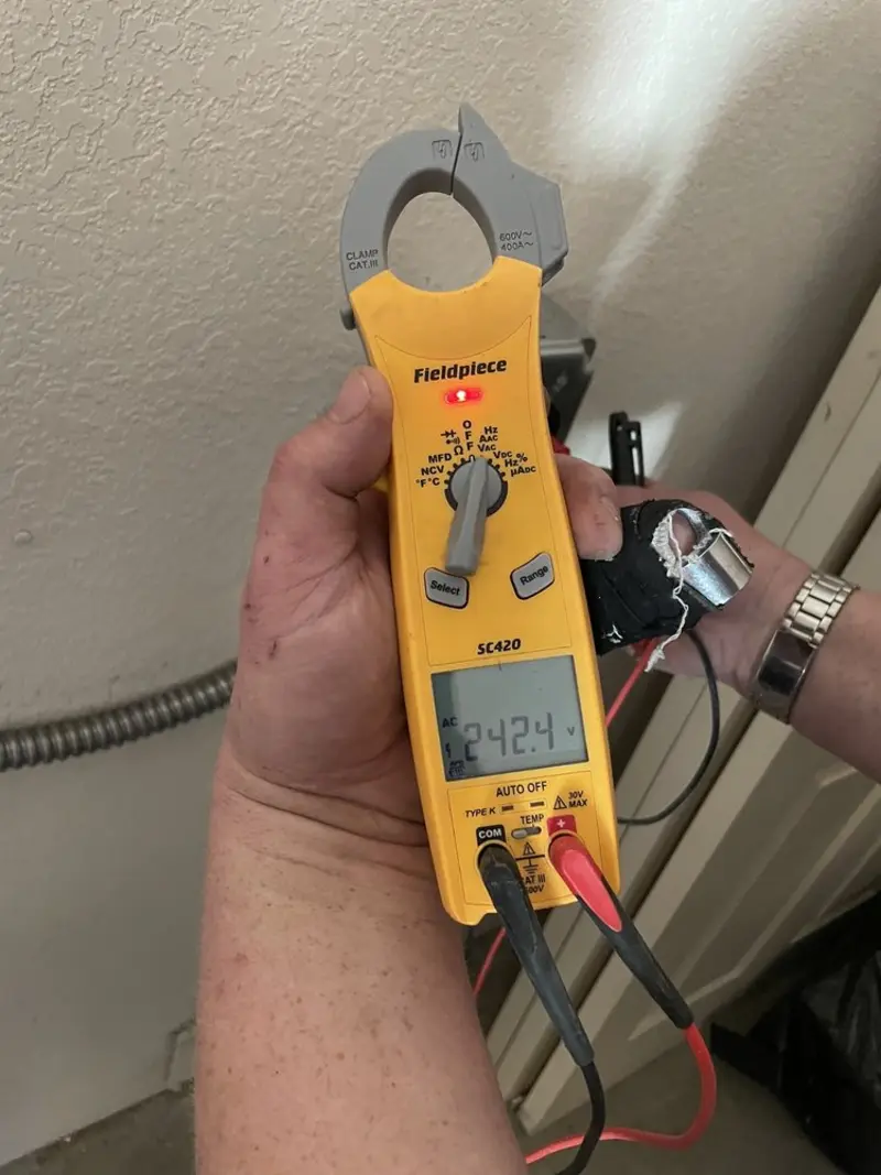 Voltage testing with clamp meter during Recessed Lighting Installation in Groton